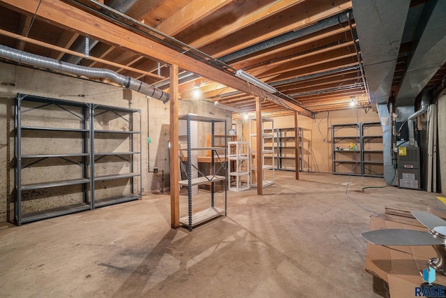 unfinished basement featuring heating unit