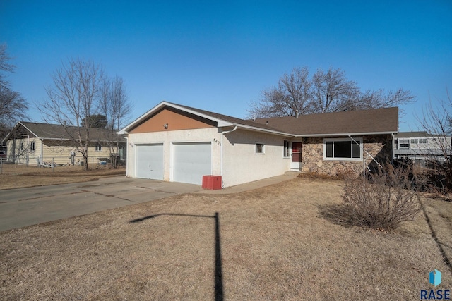 ranch-style house with an attached garage, stone siding, concrete driveway, and stucco siding