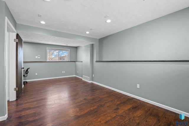 unfurnished room with recessed lighting, visible vents, baseboards, and wood finished floors