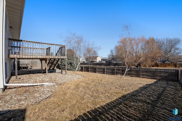 view of yard featuring a fenced backyard, stairway, and a deck