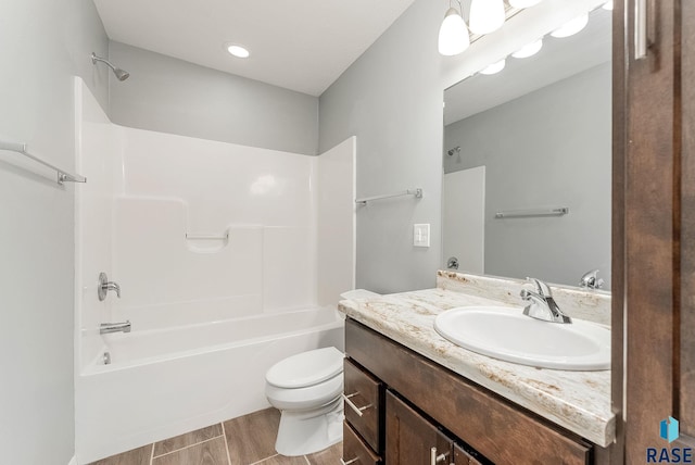 bathroom featuring vanity, wood finished floors, toilet, and tub / shower combination