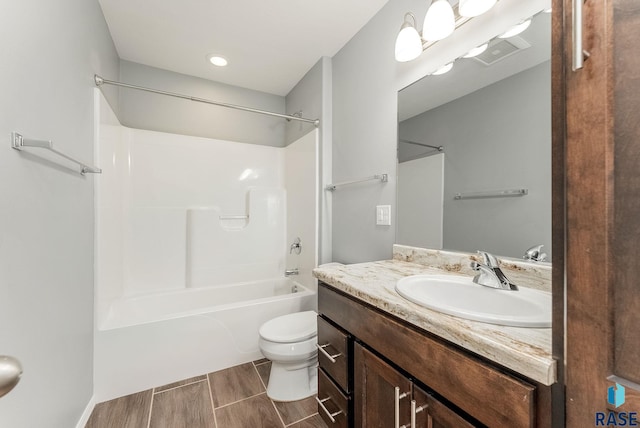 full bathroom with wood finish floors, visible vents, toilet, shower / bathtub combination, and vanity