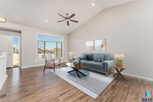 living room with high vaulted ceiling, wood finished floors, baseboards, and ceiling fan