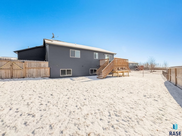 rear view of house with a deck and a fenced backyard