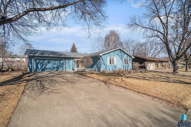 ranch-style home featuring driveway and an attached garage