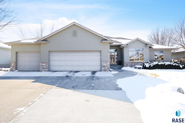 ranch-style house with stone siding and an attached garage