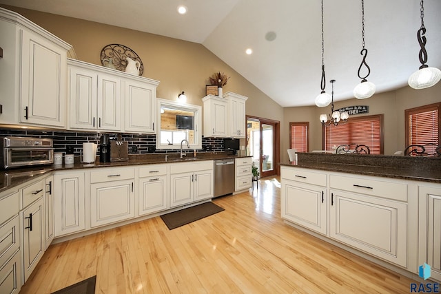 kitchen featuring decorative backsplash, dishwasher, light wood-style flooring, and a sink