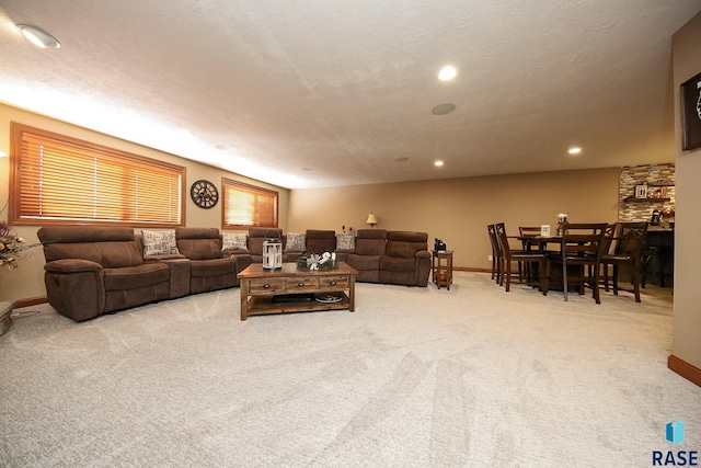 living room with baseboards, carpet floors, a textured ceiling, and recessed lighting