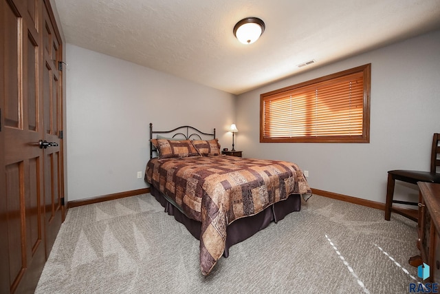 bedroom featuring carpet floors, visible vents, and baseboards