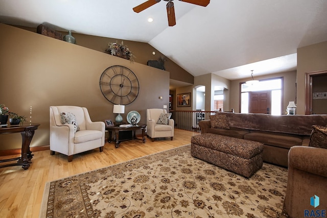 living area featuring vaulted ceiling and wood finished floors