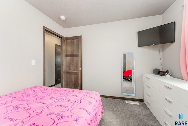 carpeted bedroom featuring visible vents and baseboards