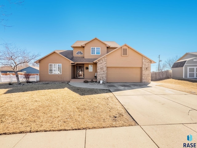 traditional home with roof with shingles, a storage unit, fence, driveway, and a front lawn