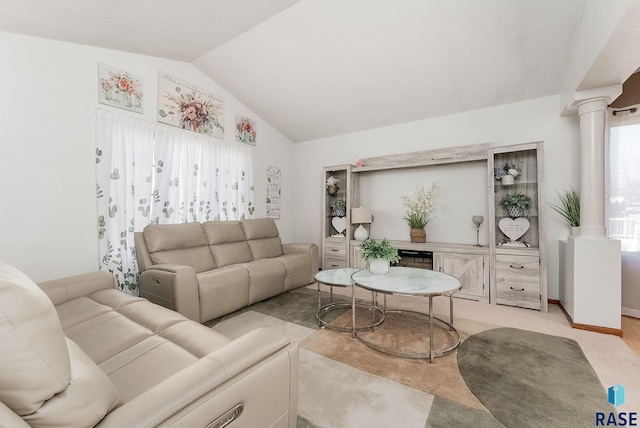 living area featuring vaulted ceiling, light colored carpet, decorative columns, and baseboards