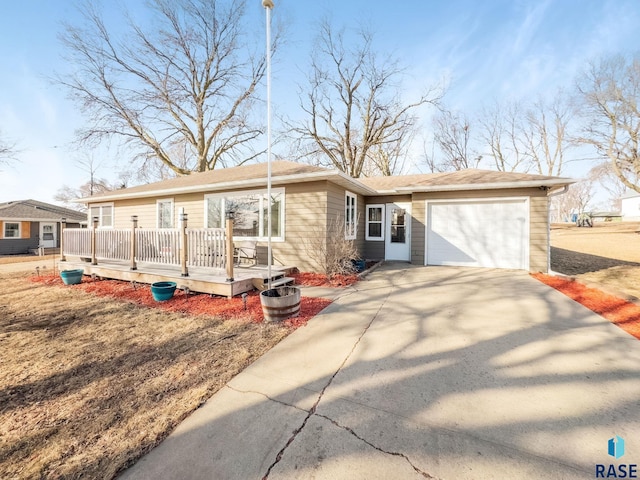 ranch-style house featuring driveway, a deck, and an attached garage