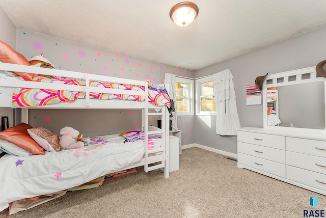 bedroom featuring carpet and baseboards