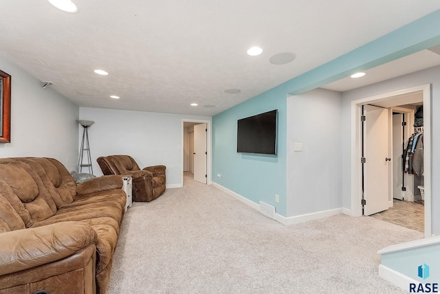 living room featuring baseboards, recessed lighting, visible vents, and light colored carpet