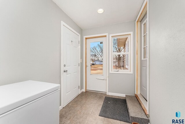 doorway to outside with baseboards