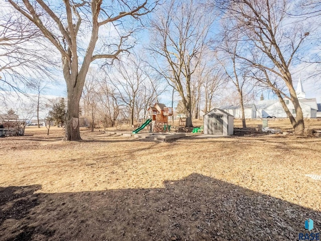 view of yard with a playground, a shed, and an outdoor structure