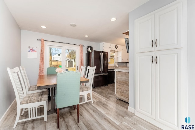 dining area with light wood-style flooring, baseboards, and recessed lighting