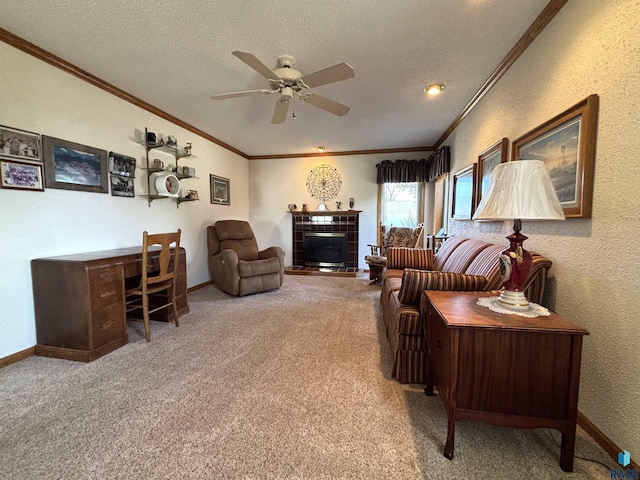 living area with baseboards, a tile fireplace, crown molding, a textured ceiling, and carpet flooring