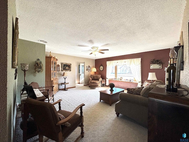 living area with a textured ceiling, carpet, and a ceiling fan