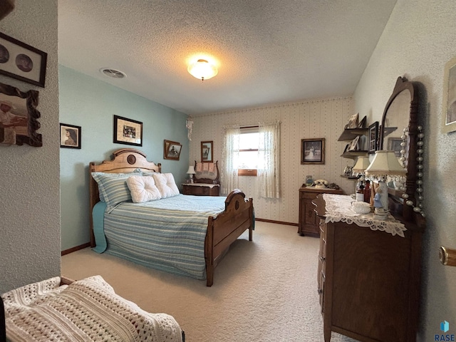 bedroom with light carpet, wallpapered walls, visible vents, baseboards, and a textured ceiling