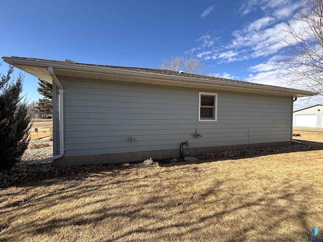 view of property exterior featuring a lawn