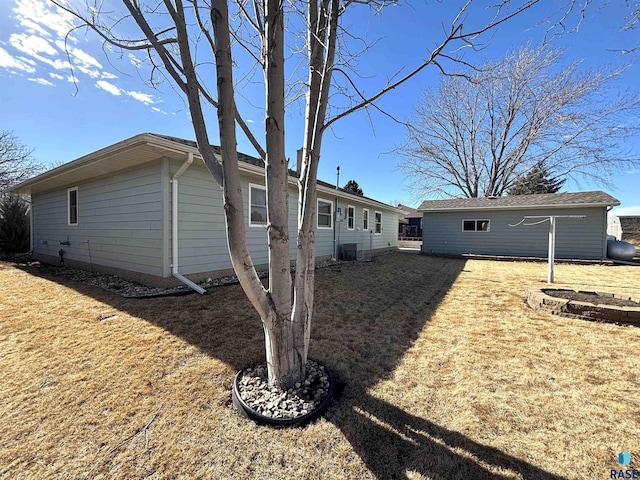 back of property featuring an outbuilding and cooling unit