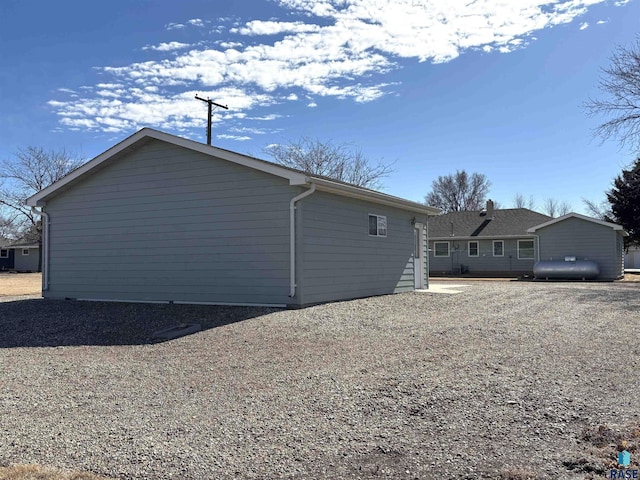 view of home's exterior featuring gravel driveway