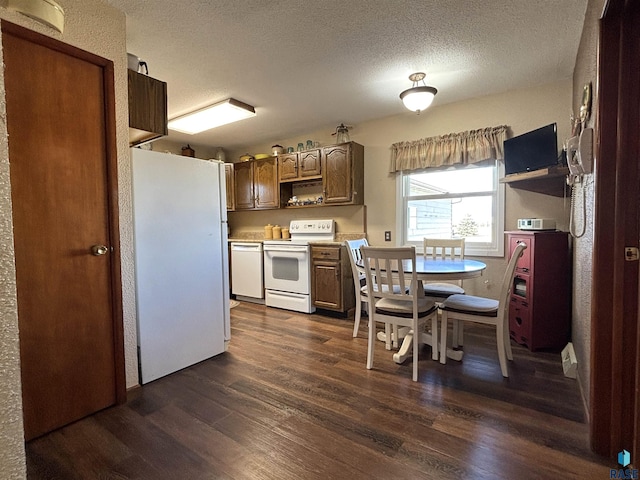 kitchen featuring dark wood-style flooring, open shelves, light countertops, a textured ceiling, and white appliances