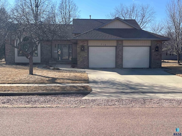 view of front of home with concrete driveway, brick siding, an attached garage, and roof with shingles