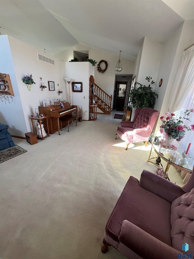 living room with stairs, carpet floors, lofted ceiling, and visible vents