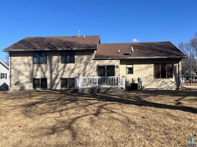 back of house featuring a yard and a deck