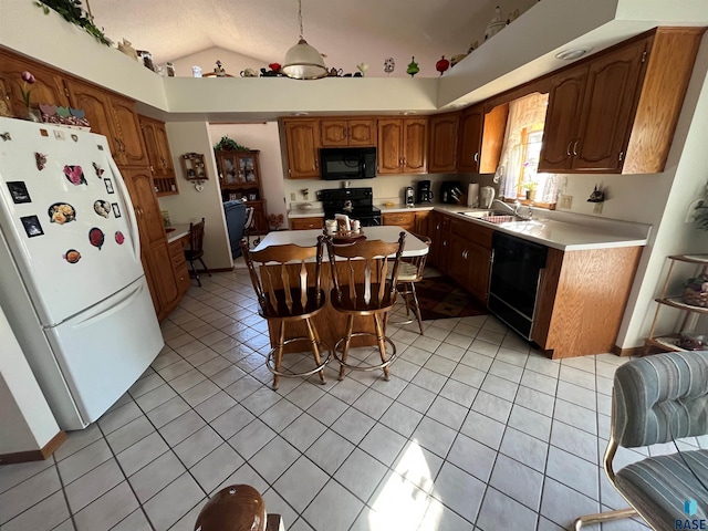 kitchen with light tile patterned floors, lofted ceiling, light countertops, a center island, and black appliances