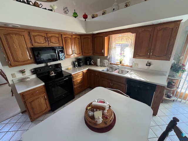 kitchen featuring light tile patterned floors, black appliances, a sink, and light countertops