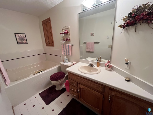 bathroom with a textured ceiling, toilet, vanity, a bath, and tile patterned floors