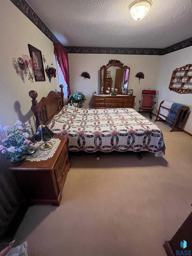 bedroom with carpet flooring and a textured ceiling