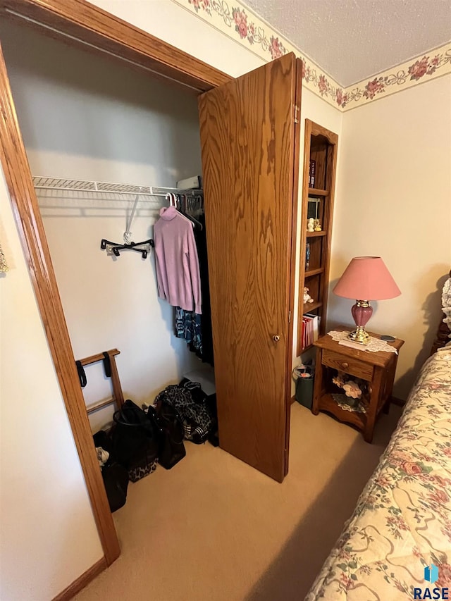 carpeted bedroom featuring a textured ceiling