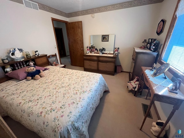 bedroom featuring light carpet and visible vents