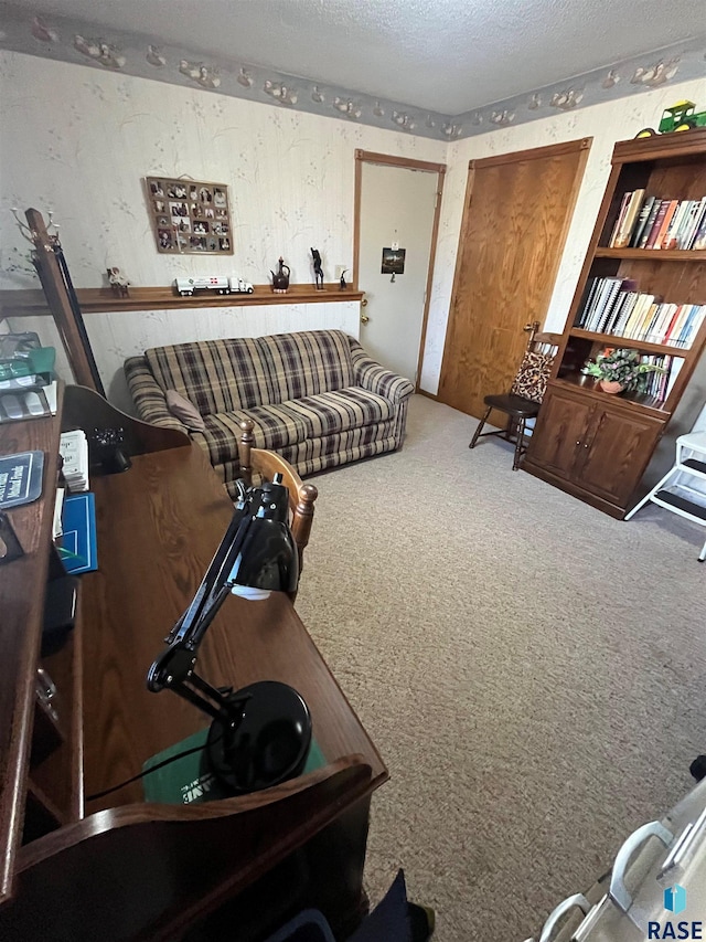 carpeted living room featuring a textured ceiling