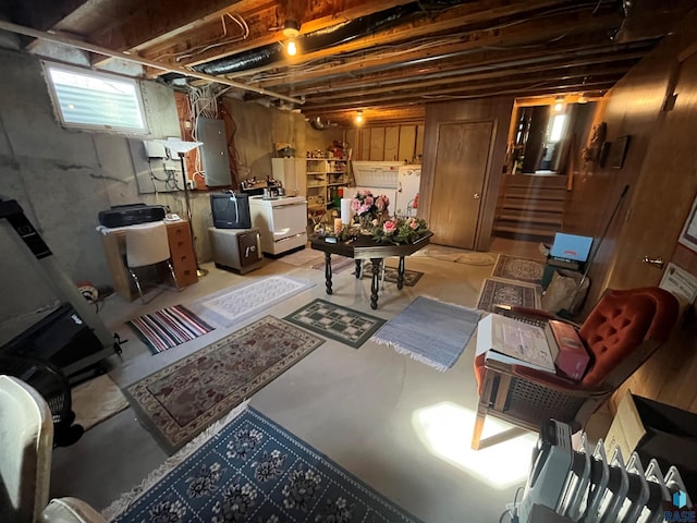 basement featuring washer / dryer, electric panel, and stairs