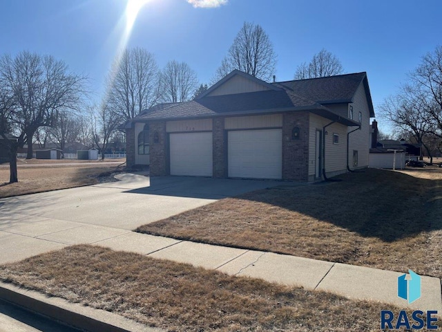 view of property exterior featuring an attached garage, concrete driveway, and brick siding