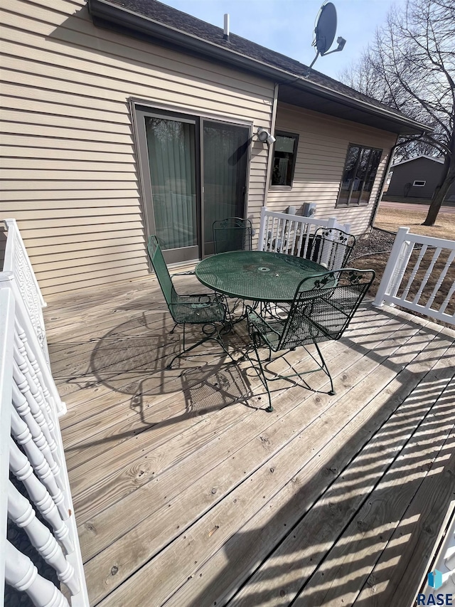 wooden deck featuring central AC unit and outdoor dining area