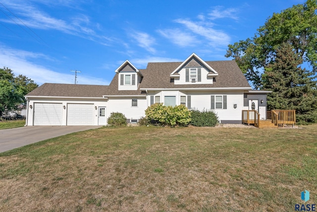 view of front of home with driveway, roof with shingles, an attached garage, and a front yard