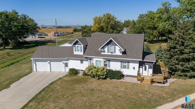 cape cod-style house featuring a garage, concrete driveway, a shingled roof, and a front lawn