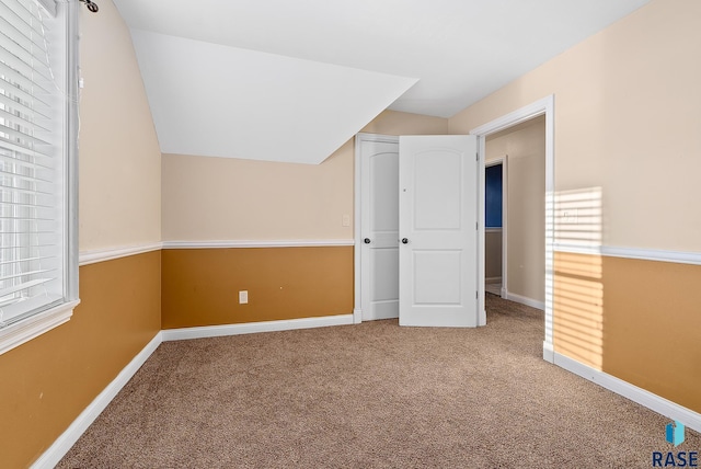 additional living space featuring carpet flooring and baseboards