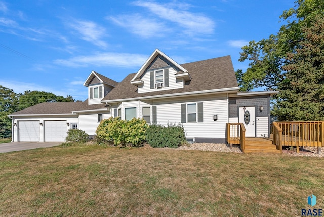 view of front facade featuring a shingled roof, a front yard, and an attached garage