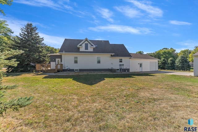 back of house featuring a lawn and a wooden deck