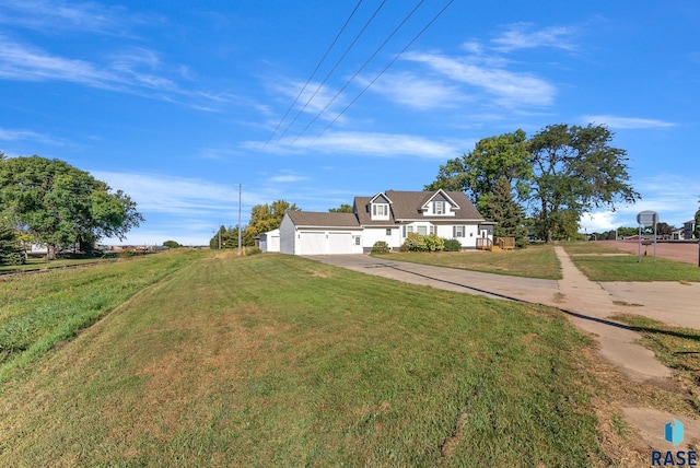 view of front of home with driveway, a garage, and a front lawn