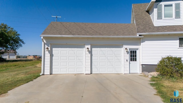 garage with concrete driveway